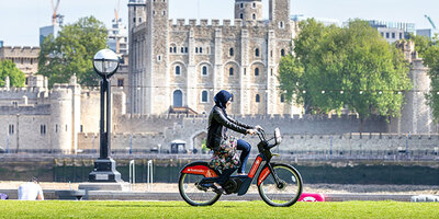 cyclist on santander cycles in front of The Tower
