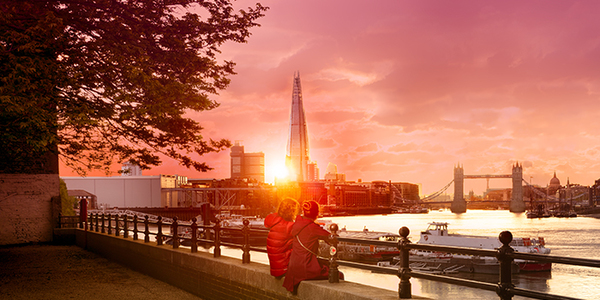 View of the Shard and Tower Bridge from across the river at sunset