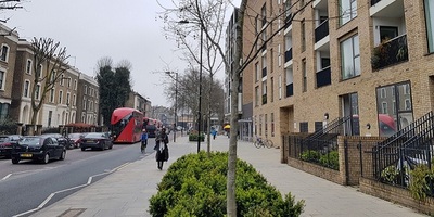 Busy London street with new development on right hand side